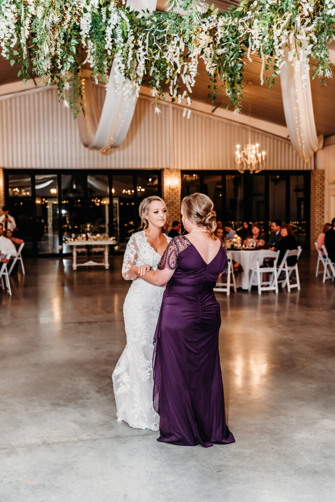 a bride dancing with her mom on her wedding day
