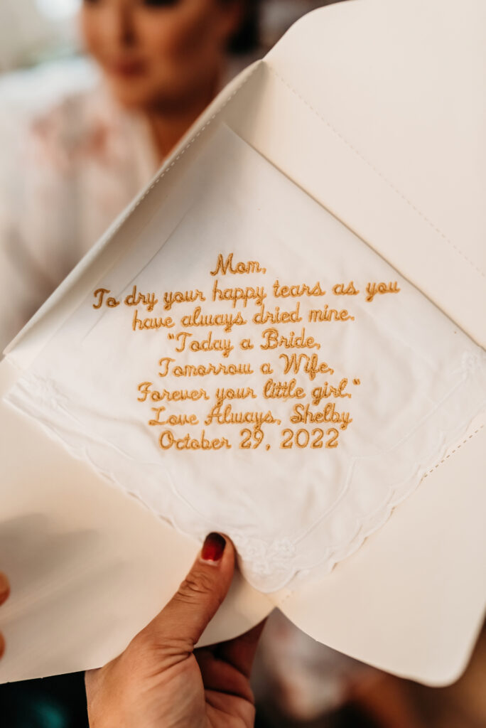 a photo of a brides gift to her mom on her wedding day. a handkerchief